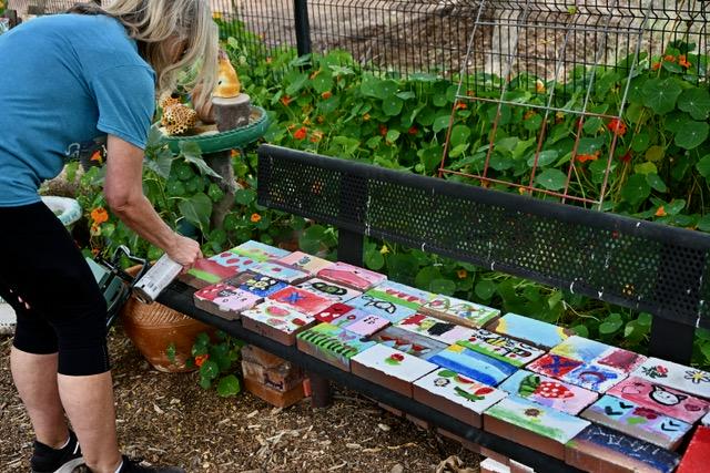 women spray painting blocks