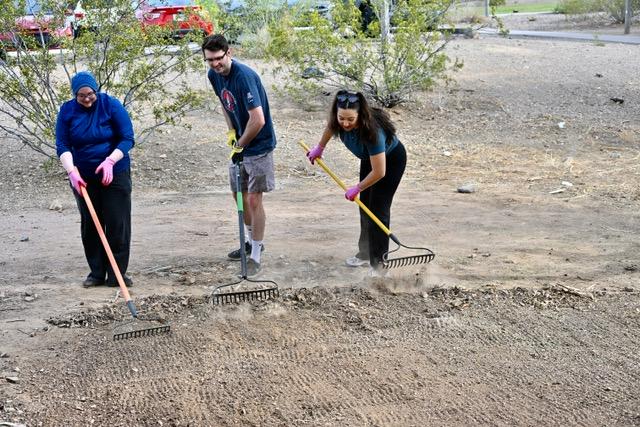 3 people cleaning the road